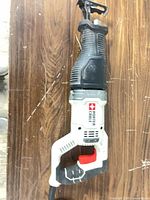 Full view of reciprocating saw showing body, handle and blade clamp