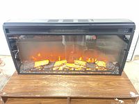 Front view lit showing simulated flames and logs