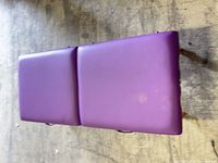 Massage table folded closed showing purple upholstery