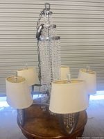 Full chandelier view showing 5 fabric shades and central crystal column