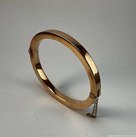Side view of 9ct rose gold hinged bangle bracelet standing upright