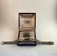 Bracelet, brooch and retailer box together