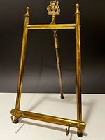 Full view of brass easel standing with rear leg extended