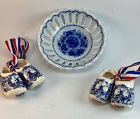 Overall view of bowl and two pairs of miniature clogs