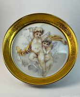 Front view of Limoges cherub dish showing motif and gilt border