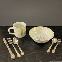 Overall view of bowl, mug, and five silverplate utensils