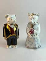 Front view of both teddy bear figurines showing attire and gold gilt