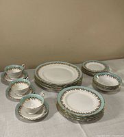 Overview of stacked dinnerware set with cups and saucers
