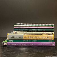 Stacked view of all seven hardcover gardening books showing spines