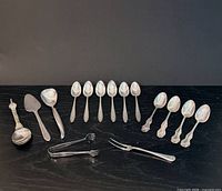 Entire 15-piece flatware lot laid out