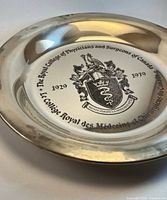 Front view showing engraved coat of arms and anniversary dates