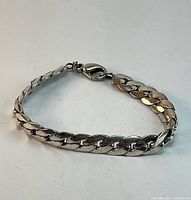 Full view of sterling silver curb link bracelet in circular layout