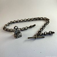 Chain with T-bar, swivel clip and attached wax seal fob displayed in full