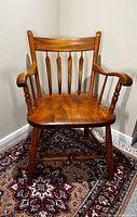 Front view of solid wood Windsor-style armchair showing overall design