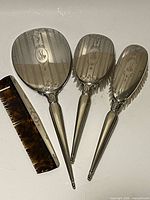 Full view of mirror, two brushes and comb