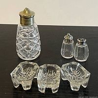 all six pieces: three salt cellars, crystal shaker, pair paneled shakers