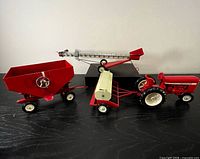 All four Ertl International Harvester die-cast items side by side