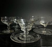 Group of coupes and plates showing etched patterns