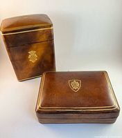 closed playing card box and desktop box showing exterior leather finish and crest