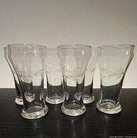 Front view of all six etched glasses showing shape and decoration