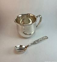 David Andersen silver spoon and Birks cup side by side