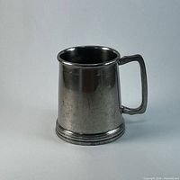 Front three-quarter view of pewter tankard