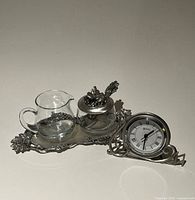 Full lot displaying creamer, sugar bowl with lid and spoon on tray, plus desk clock