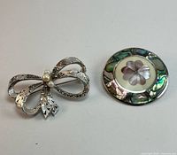 both brooches front view