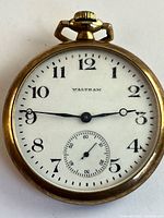 Front view of Waltham pocket watch showing dial and hands