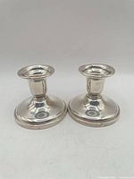 Front view of both Birks sterling silver candlesticks