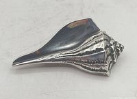 Front view of sterling conch shell brooch