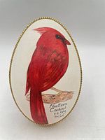 Front view of egg showing Northern Cardinal artwork and edition inscription