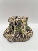 Front view of tree stump ceramic money box