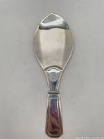 Full view of silver-plated rice serving spoon