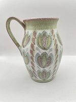 Side profile showing tulip motif and handle