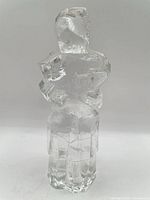 Front view of clear glass cubist embracing couple sculpture