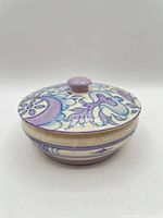 Closed covered dish showing exterior pattern and knob