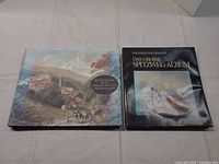 Front covers of both hardcover books side by side