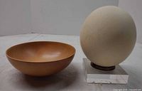 Bowl and egg on stand side by side giving size context