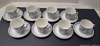 Full set of 8 cups on saucers displayed