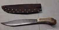 Knife with sheath displayed