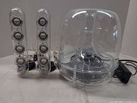Full set showing subwoofer, two satellite speakers, power adapter and cables