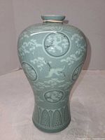 Front view of celadon vase showing crane roundels and overall form