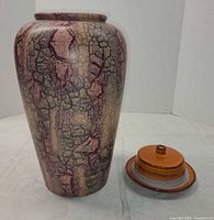 Vase beside covered dish showing overall form and colour