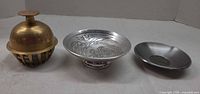 Front view of all three metal dishes side by side