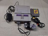 Console, controller, power adapter, AV cable, NES cartridge displayed together