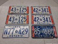 Front view of all six plates showing numbers and years