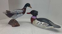Both duck decoys side by side showing relative sizes and mounting