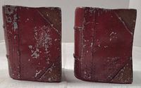 front view of both red metal bookends showing paint wear