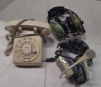 Group shot of rotary phone, Telex headset, David Clark headset